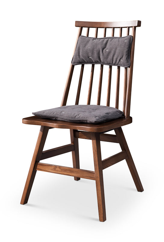 A minimalist soft backed solid wood dining chair