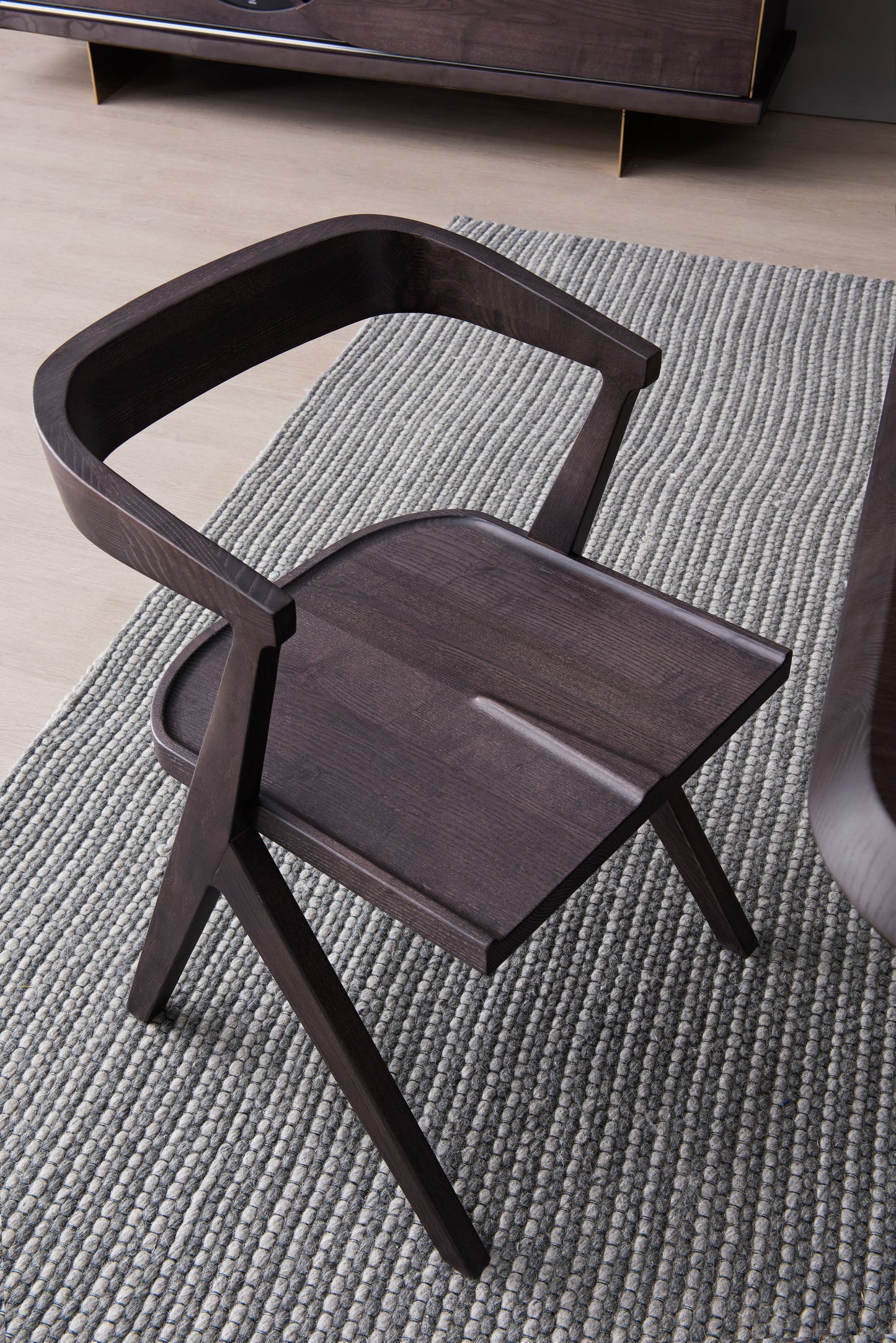 A dining chair made entirely of solid wood with a strong sense of design
